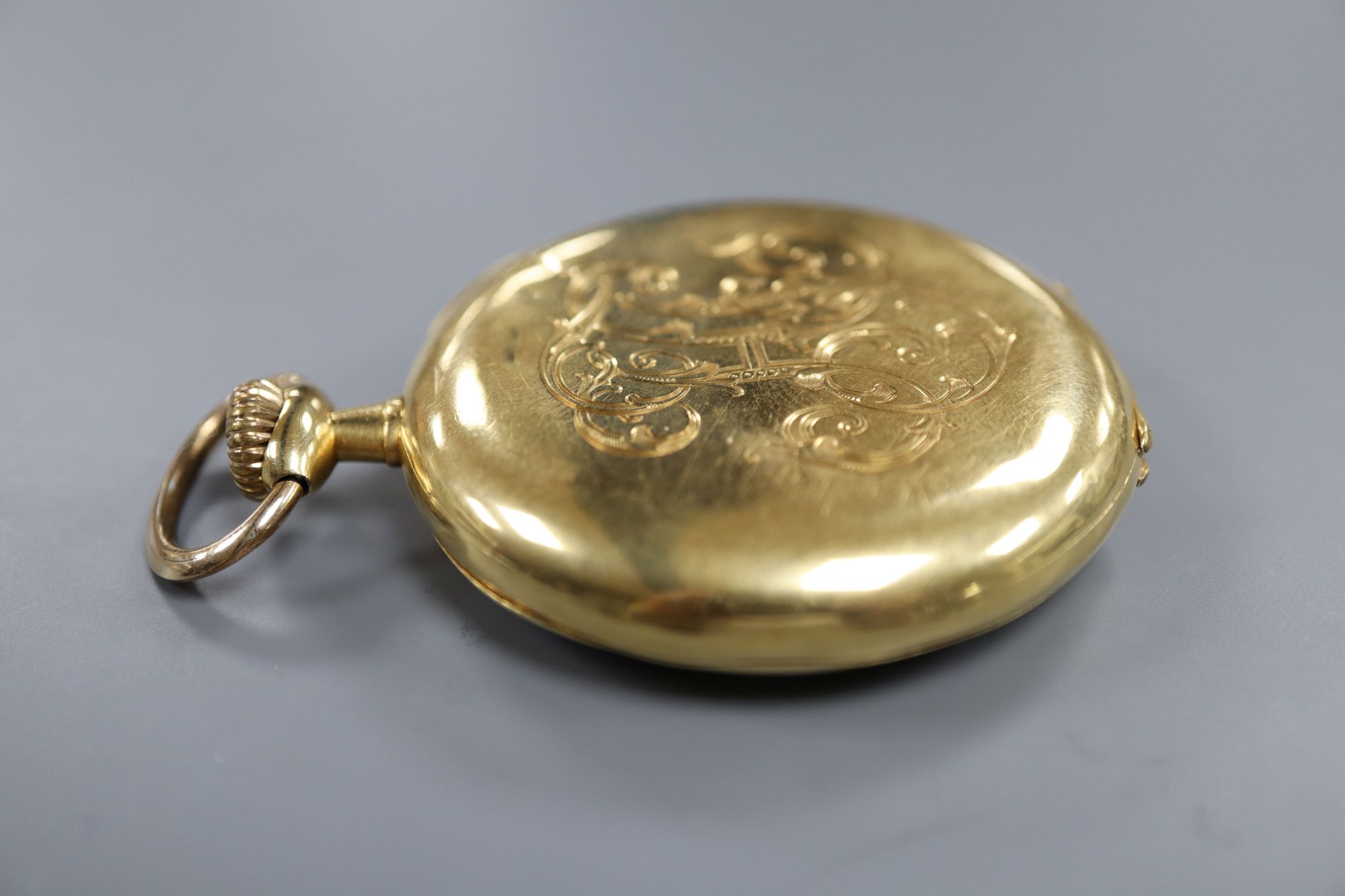 A continental 18k yellow metal open face pocket watch, with Arabic dial and subsidiary seconds,